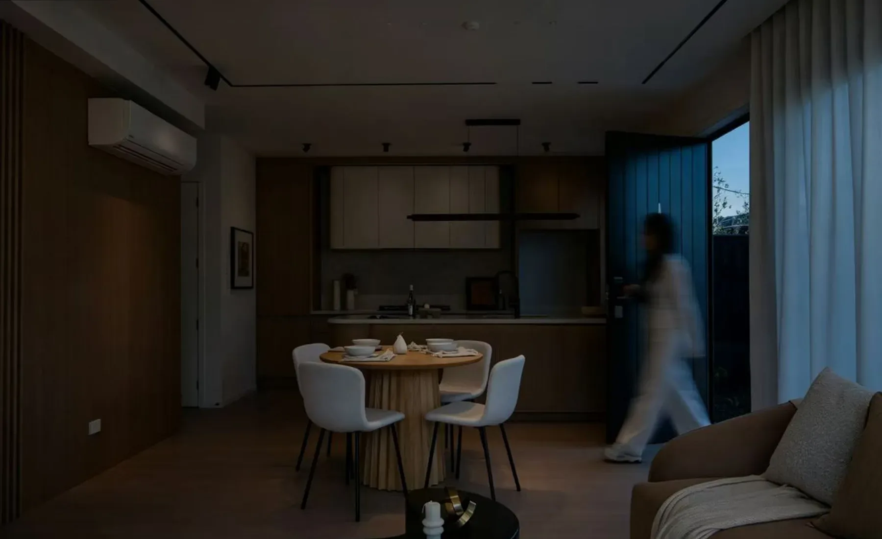 The same kitchen and living room with the lights off