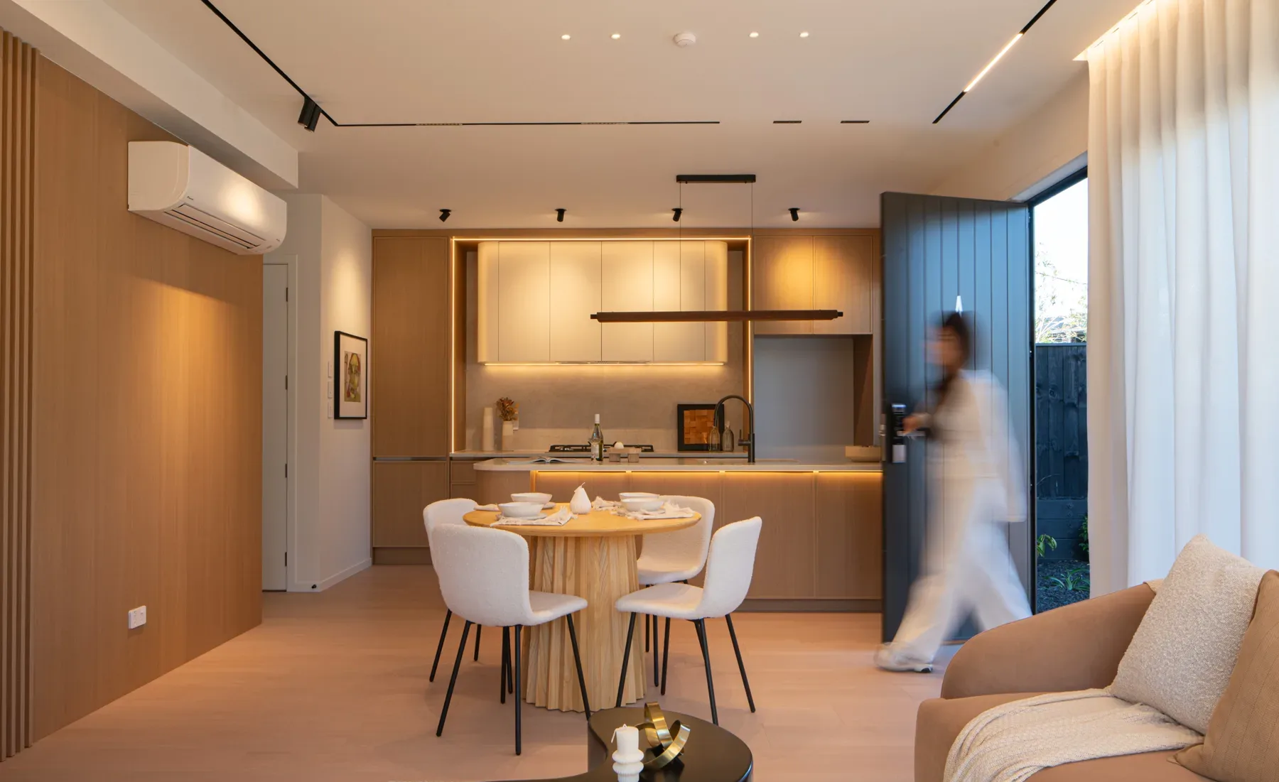 Kitchen and living room with the lights on